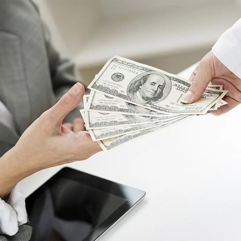 Cash being handed back across a desk
